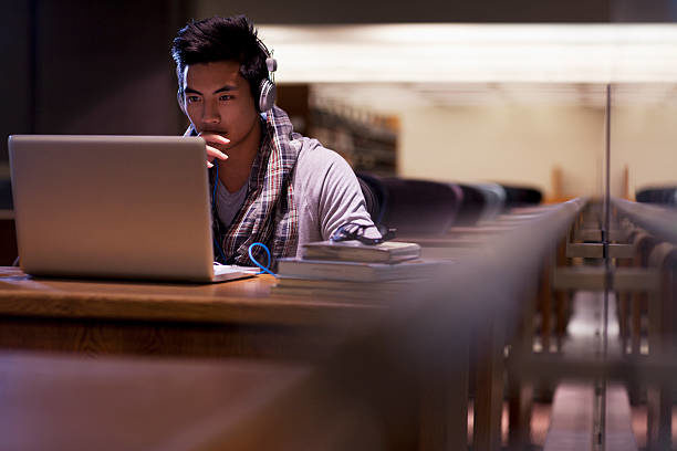 Stock photo of a student in front of a computer