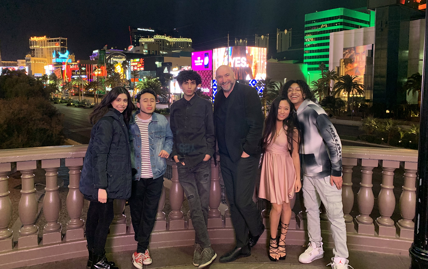 Professor and students posing for picture with Las Vegas Strip in the background.