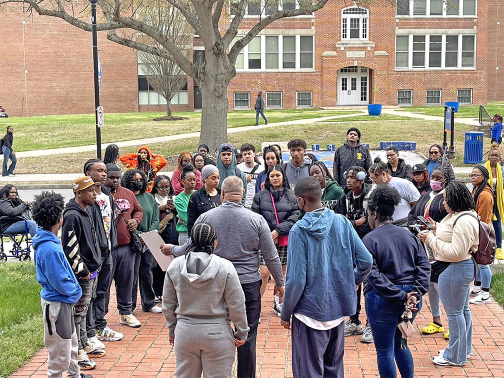 Students listening to speaker during a campus tour visit. 