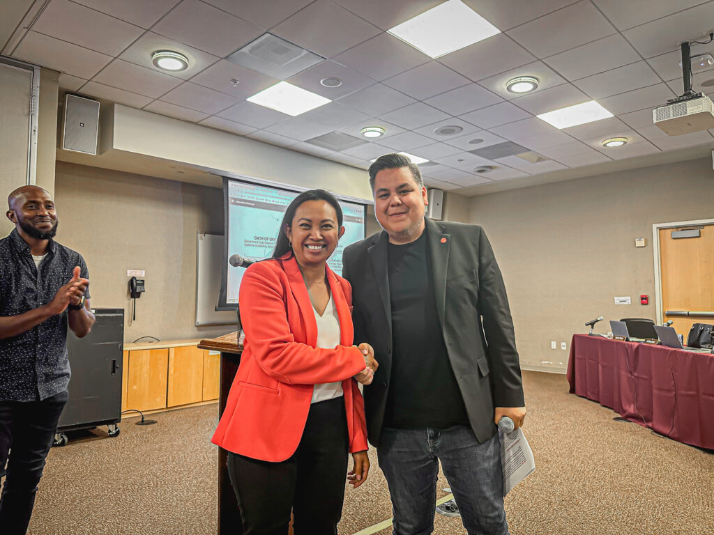 Southwestern College newly appointed Governing Board member, Kris Galicia Brown shaking hands with Governing Board President, Roberto Alcantar.