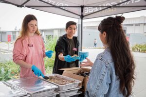 Southwestern College Associated Student Organization members handing out food for Finals Stress Relief Week.