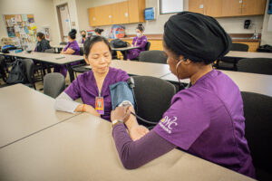 Southwestern College Vocational Nursing Program student treating another student.