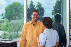 Field of Study Success Coach for the Men of Color Success & Excellence program, Victor Brown engaging in an insightful conversation with Kamryn Rayson, another dedicated Field of Study Success Coach, during the Black Student Success Week event.