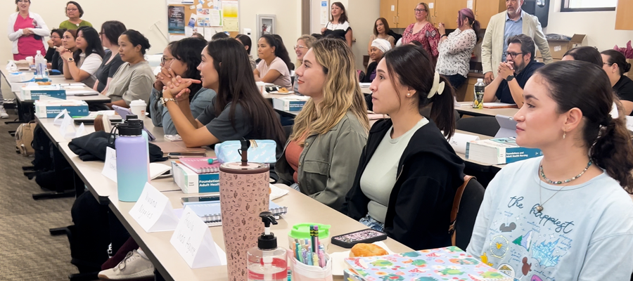 Southwestern College Vocational Nurse students seating in class, while being told they have been granted a full scholarship into the program. 